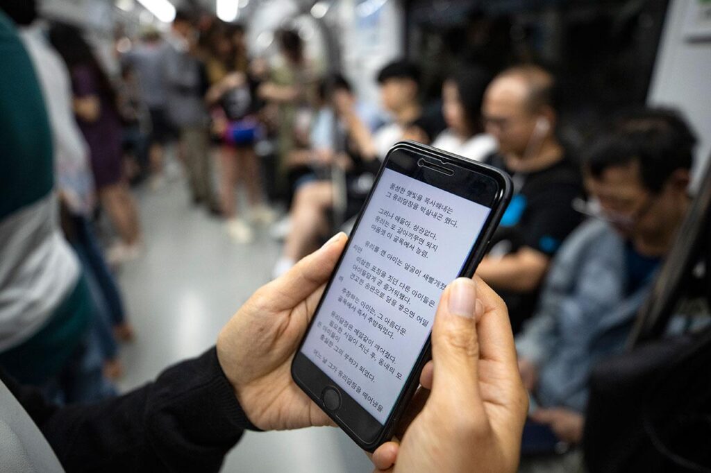A reader browsing web novels on a digital reading platform before choosing a series to follow.