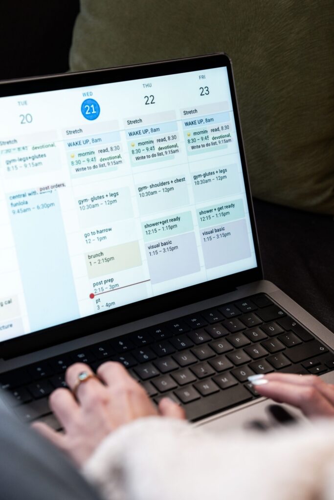 Digital calendar on a laptop, illustrating how readers compare an author's promised release schedule with actual chapter updates.