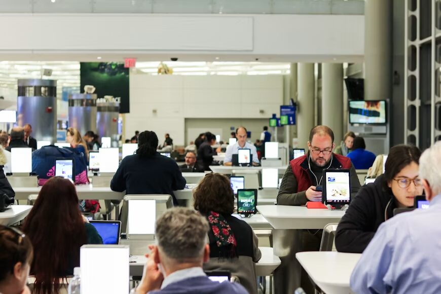 Modern newsroom coordinating news coverage before stories are distributed to publishers worldwide.